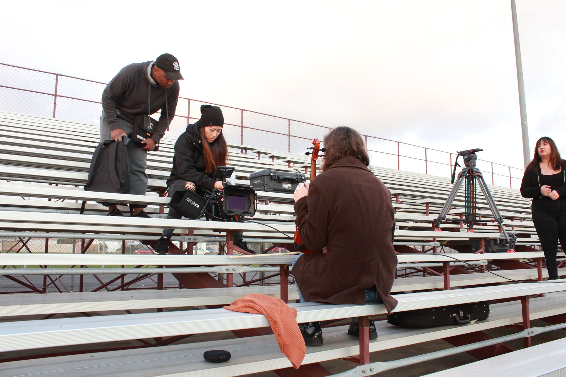 Crew setting up in the bleachers between takes