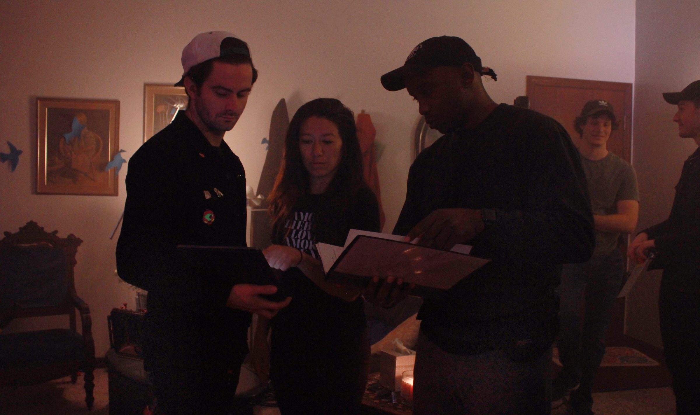 Isaiah reading through a scene with actors and crew on the set of Bow