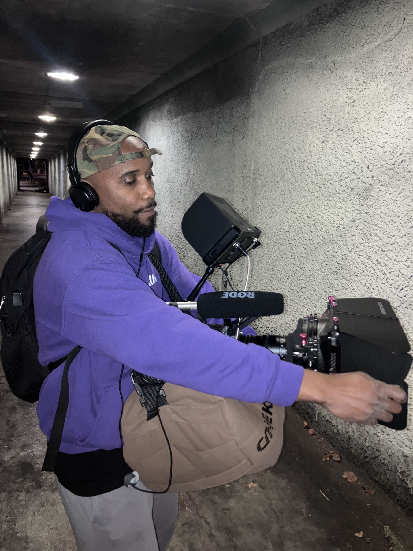 Isaiah with a cinema camera in a tunnel