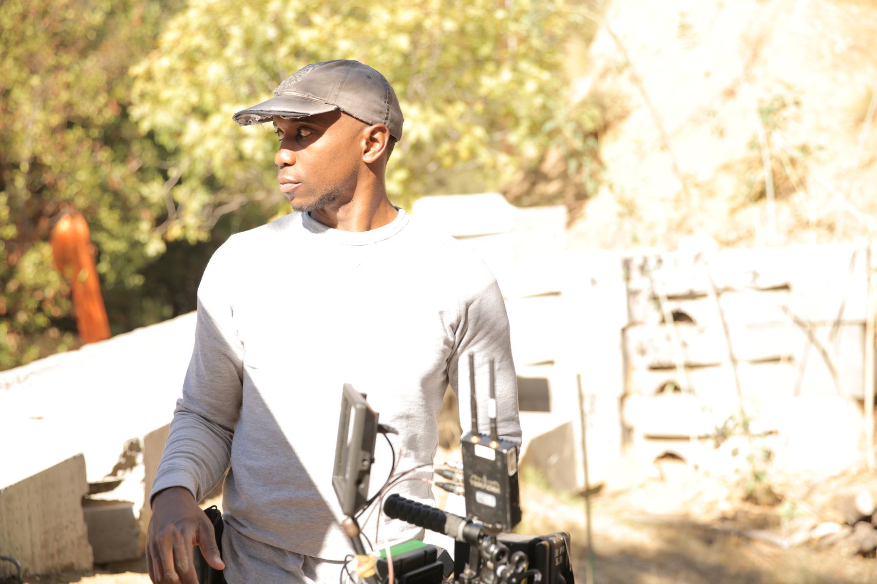 Isaiah with a camera rig in late sun
